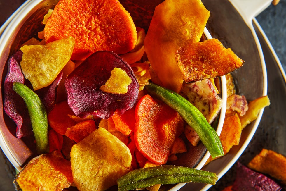 dry fruit and healthy vegetable chips, healthy vegan snack, a mixed heap yellow sweet potato purple sweet potato carrot green radish green beans and shiitake mushrooms