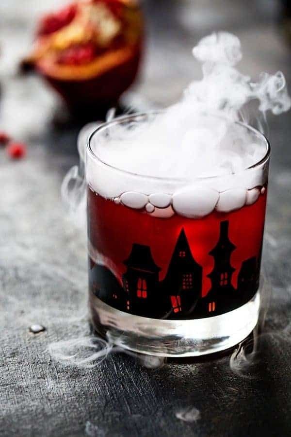 https://hips.hearstapps.com/hmg-prod/images/dry-ice-drinks-pomegranate-ginger-punch-649365a0be35b.jpeg
