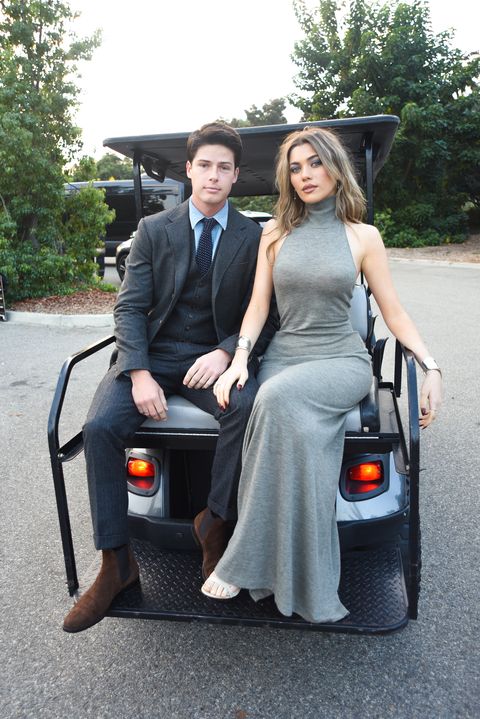 gray and his girlfriend, amelie zilber, on the back of a golf cart en route to the show