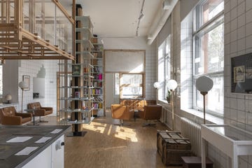 a room with a staircase and bookshelves