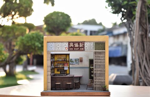 a miniature replica of a bar, shown with trees in the background for scale