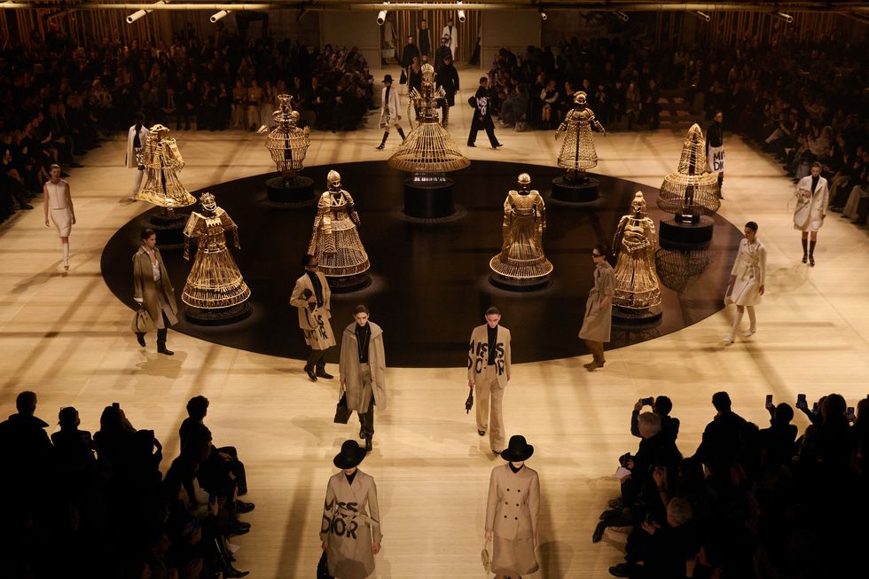 a group of people walking around a large room with a large group of people in it