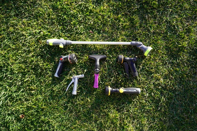 set of various watering nozzles and a wand on grass