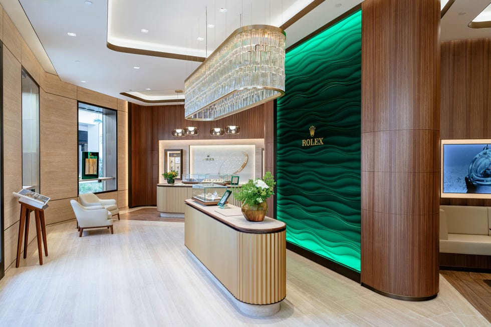 interior of a rolex boutique featuring displays and a reception area