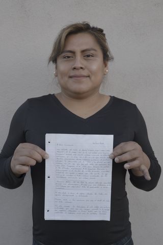 karla bautista ﻿holding up a letter sent to her in june 2019 by the cibola29, a group of trans women detained at the trans pod at the cibola county correctional facility in new mexico ﻿