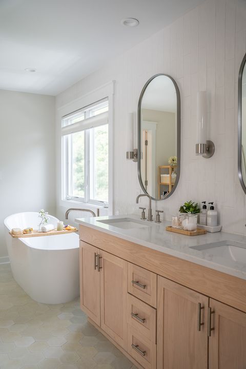neutral bathroom with soaking tub and light woods