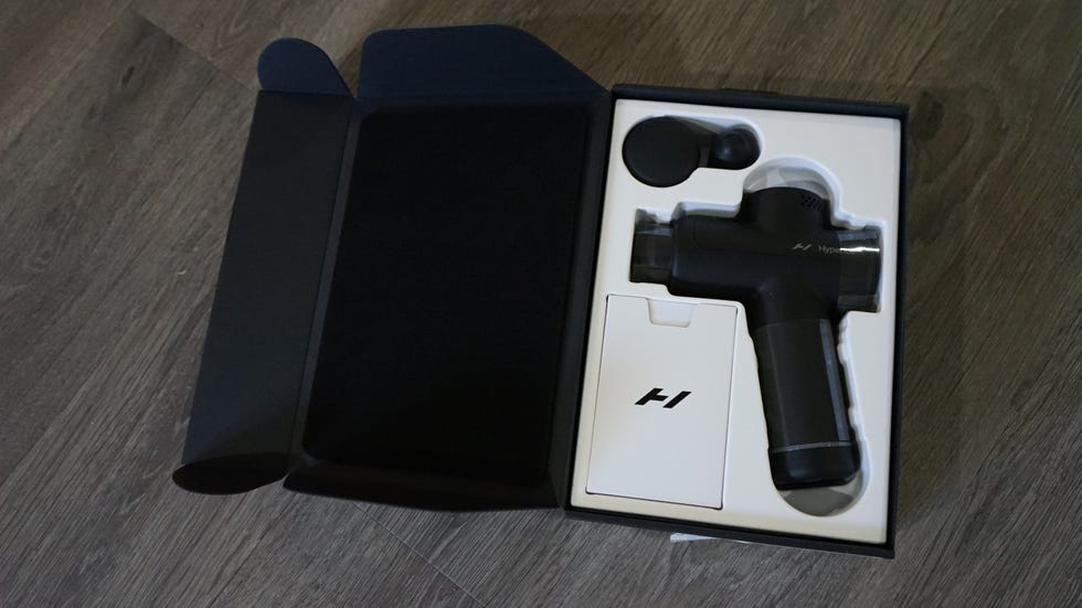 massage gun with accessories in a box