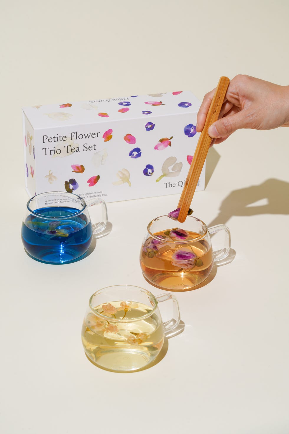 putting flowers into glass tea cups