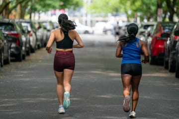two female runners on road
