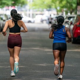 two female runners on road two female runners on road