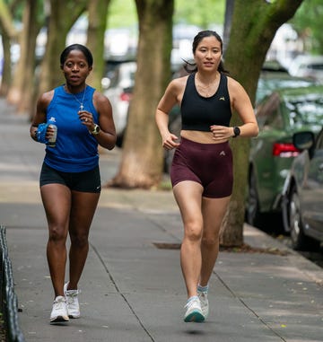 two women running together two women running together