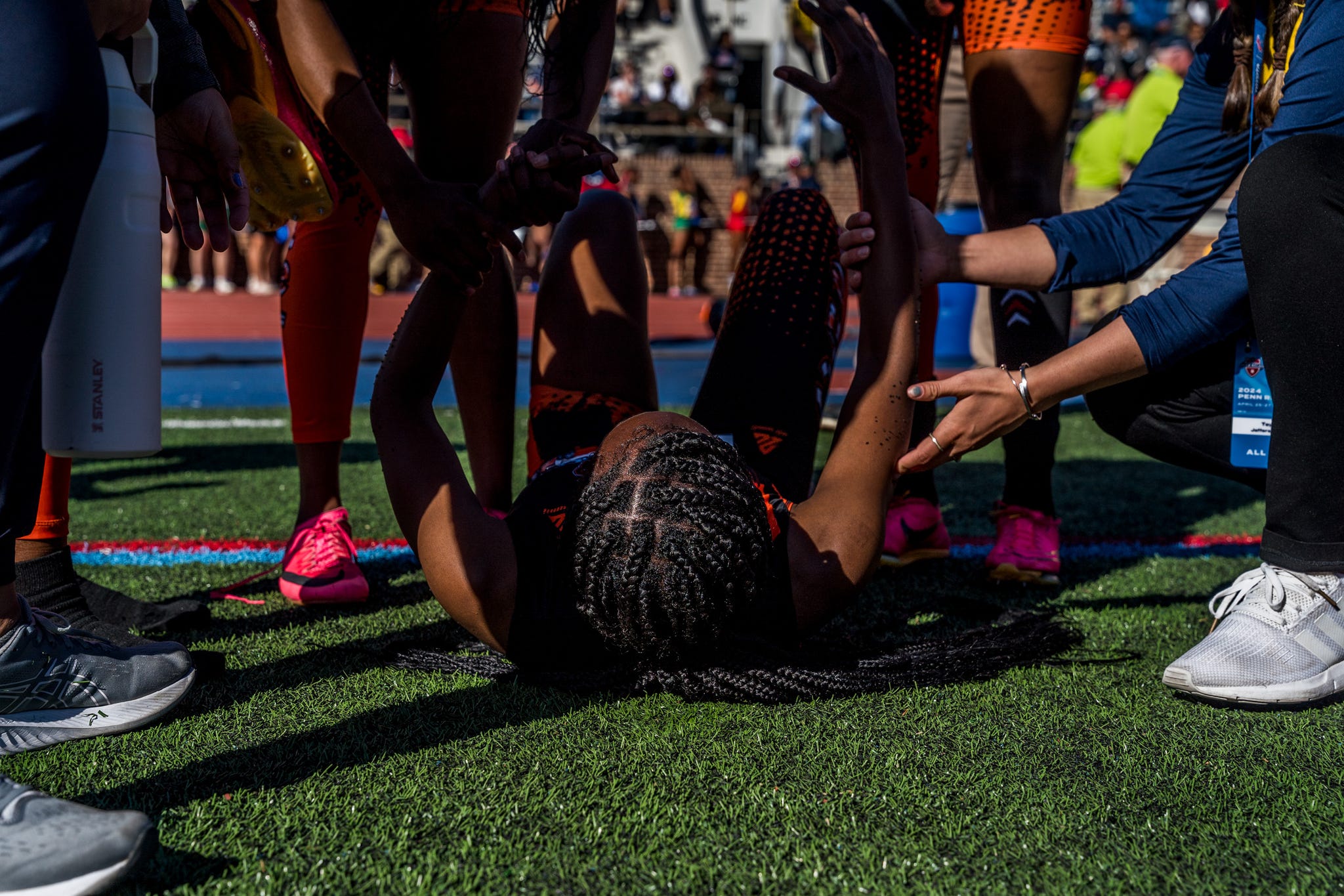 RWD people help out an athlete on the ground