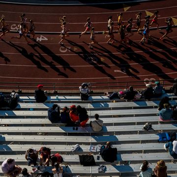 seen from above a group of runners on a track cast long shadows