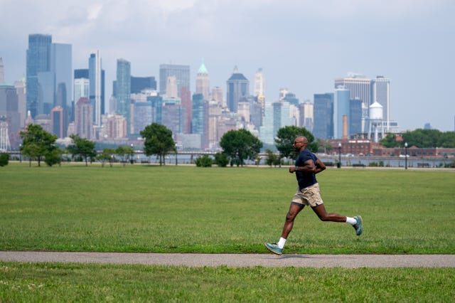 runner on a path with a city skyline in the background