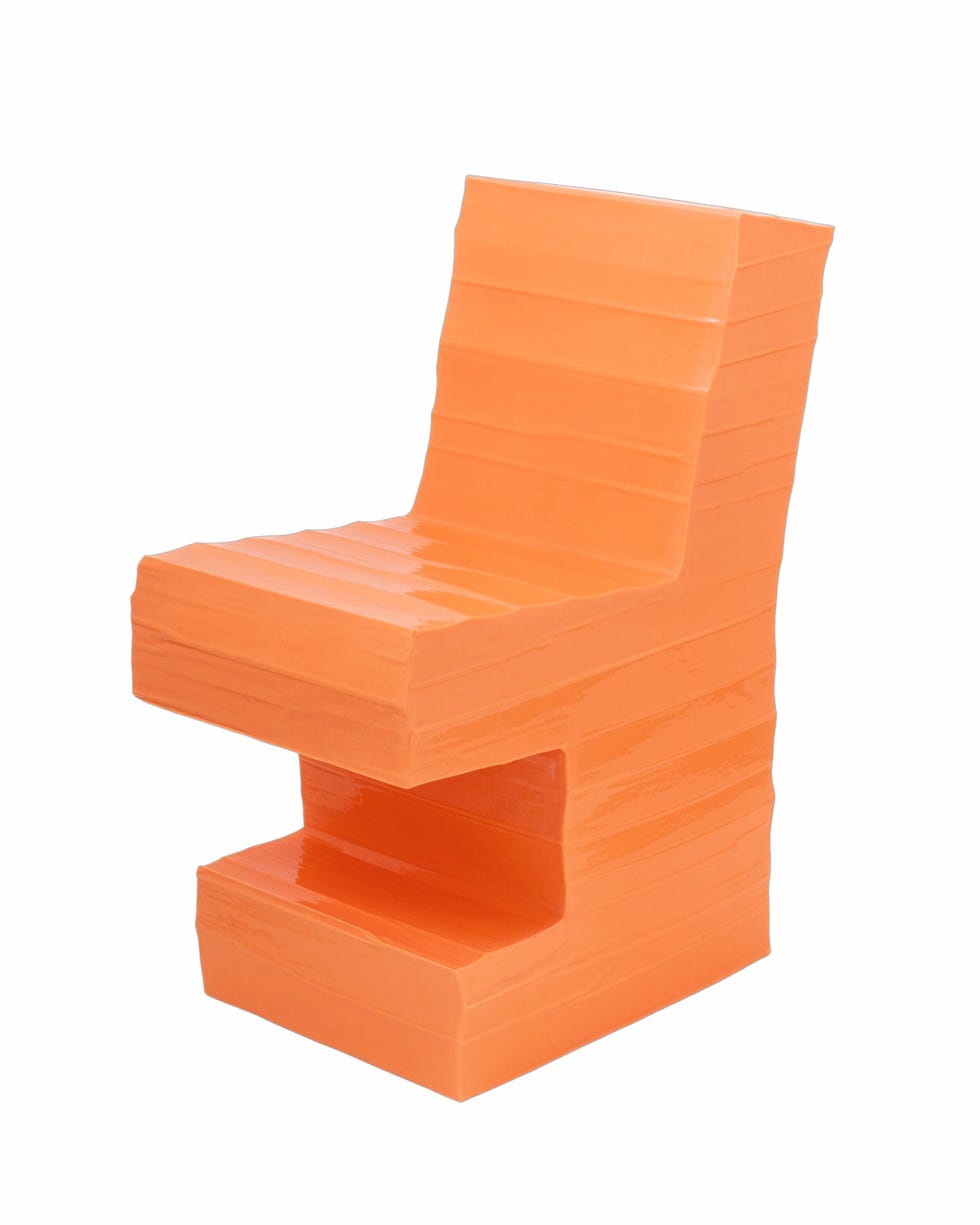 a chair featuring a blocky design with a glossy orange finish