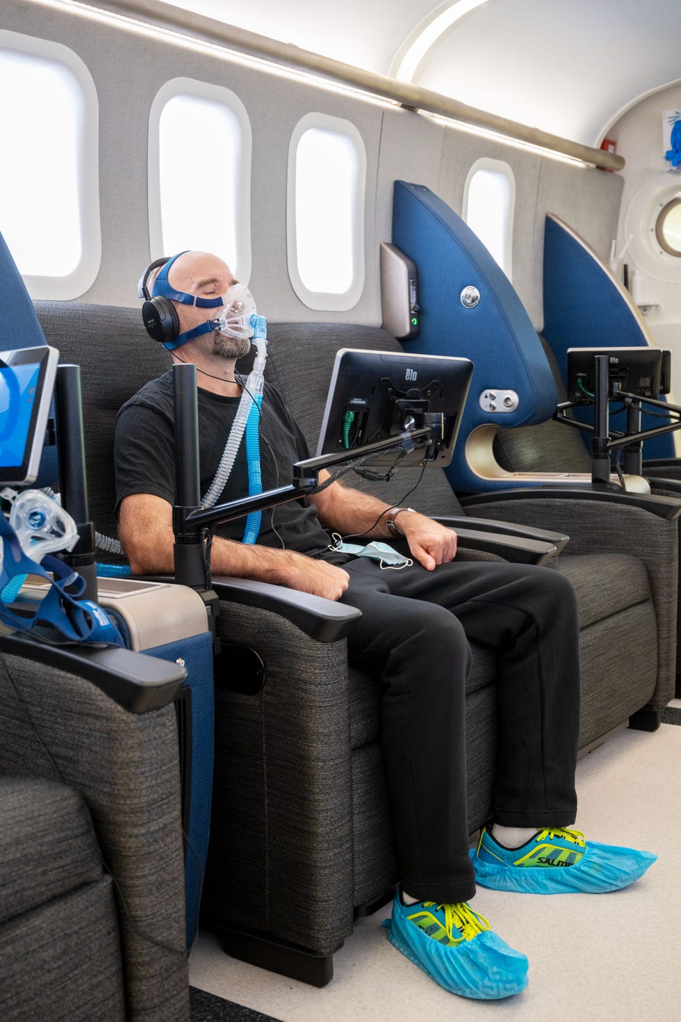 author sitting in chair in front of monitor while hooked up to oxygen