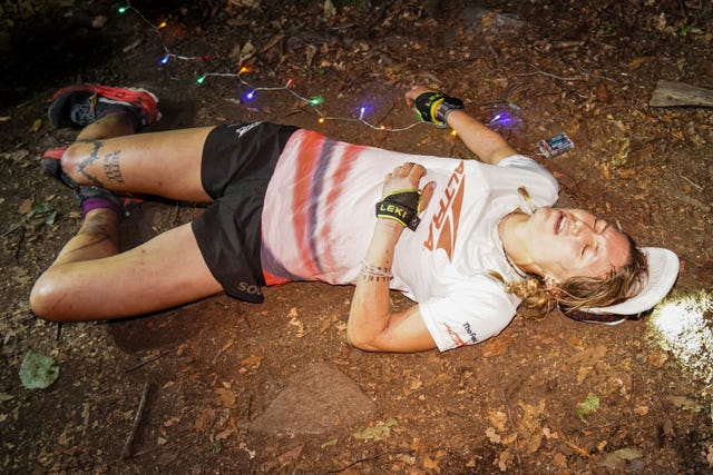 a runner lying down exhausted in the dirt