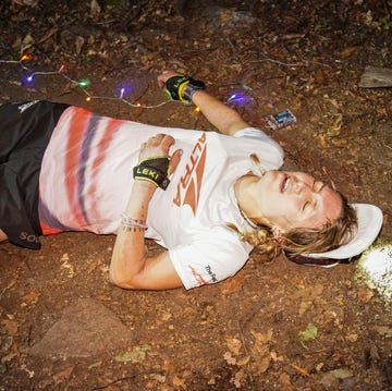 a runner lying down exhausted in the dirt a runner lying down exhausted in the dirt