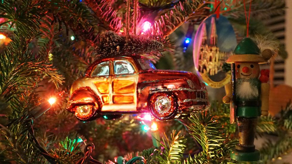 Christmas ornaments of old cars with trees on top