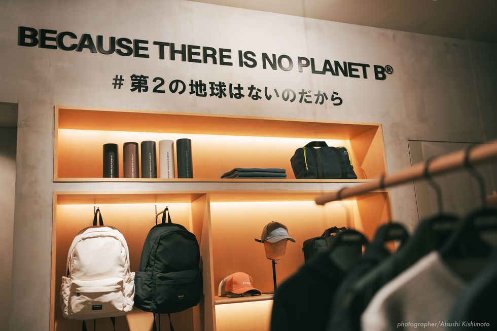 a shelf with clothes and a sign