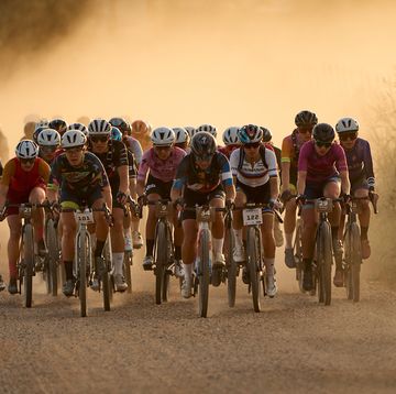 a group of cyclists riding on gravel
