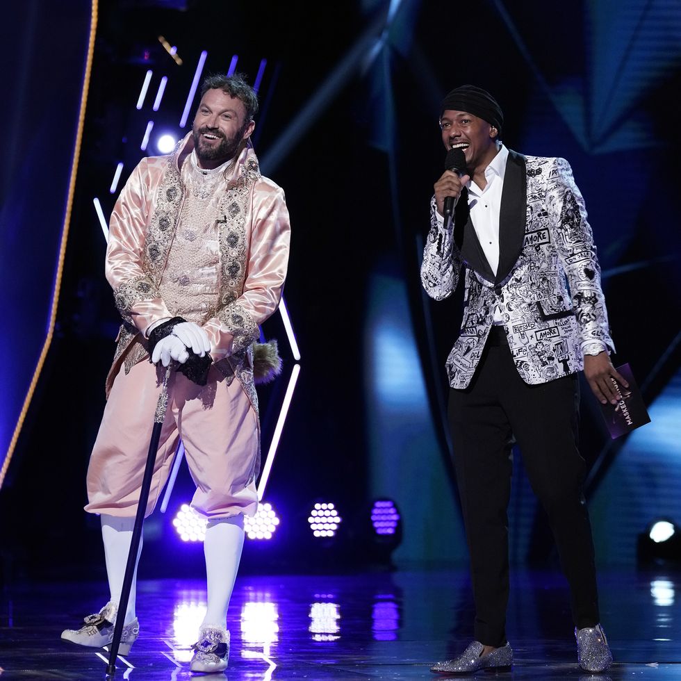 the masked singer l r brian austin green and host nick cannon in the “the group a play offs   famous masked words” episode of the masked singer airing wednesday, oct 7 800 900 pm etpt on fox © 2020 fox media llc cr michael beckerfox