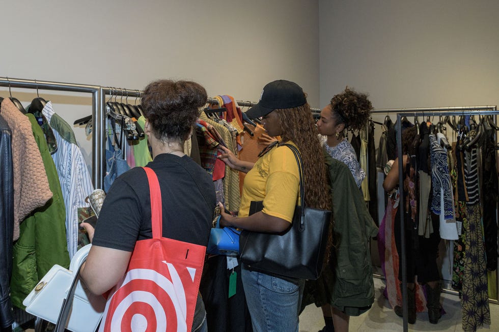 a group of people looking at clothing