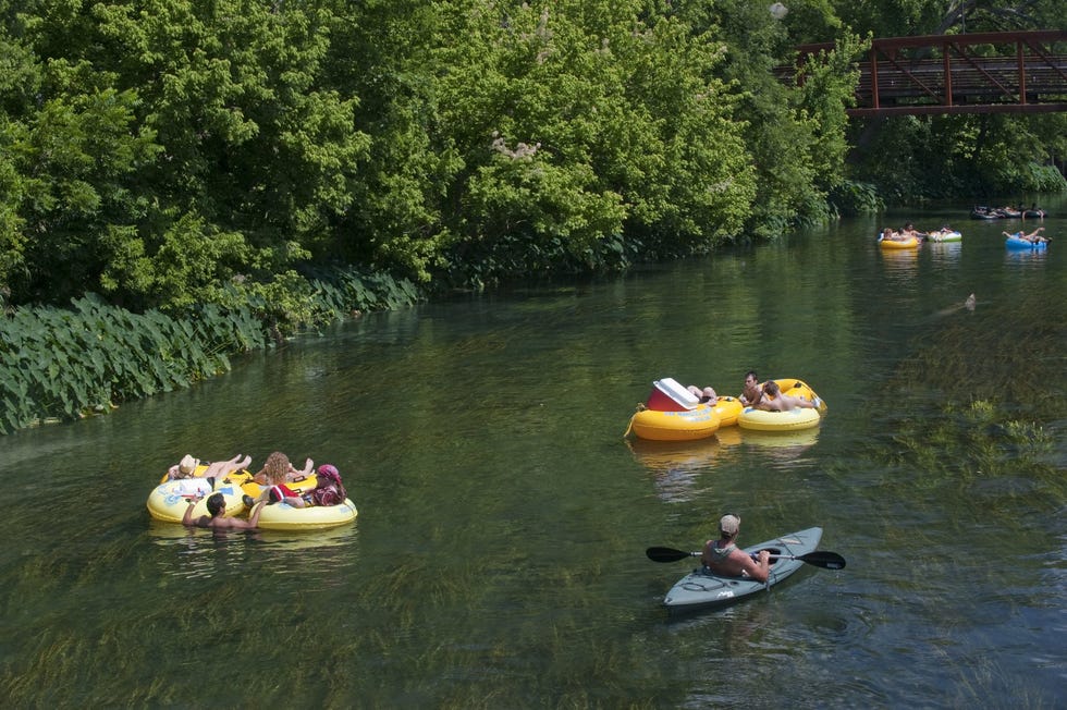 tubers and a kayaker on river