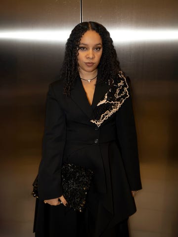 fashionable individual poses in an elevator corridor