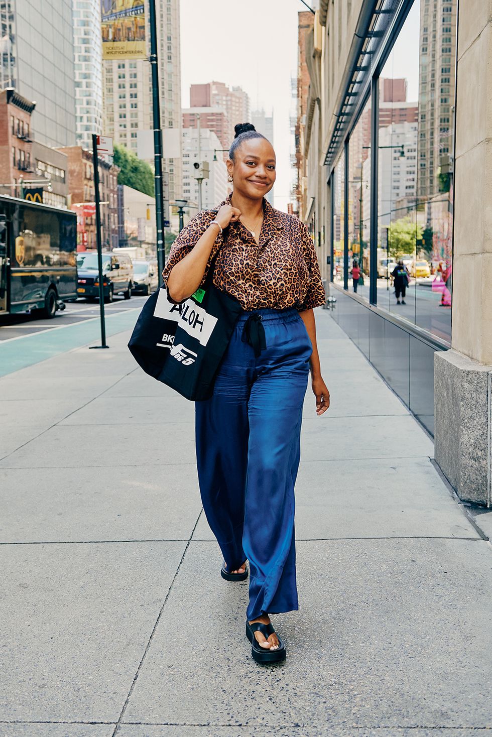 a bazaar editor wears a leopard print blouse and jeans to illustrate a guide to the best work outfit ideas 2022