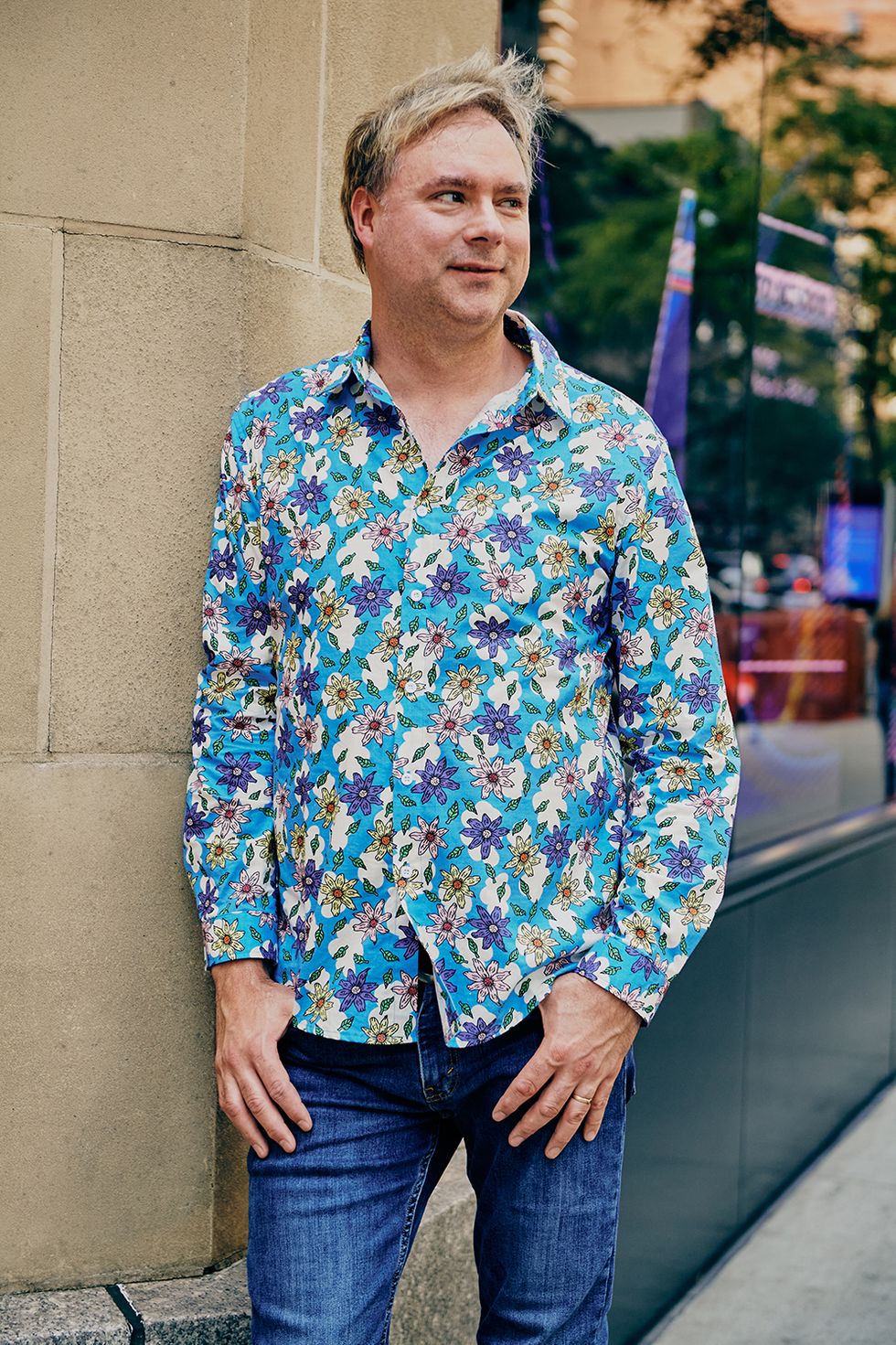 a bazaar staffer wears a printed shirt and jeans to illustrate a roundup of the best work outfit ideas from bazaar editors