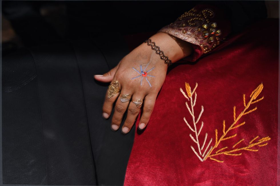 Nora Om Aly uit het dorp Al Tarfa heeft een foto van haar handen met een borduursel versierd