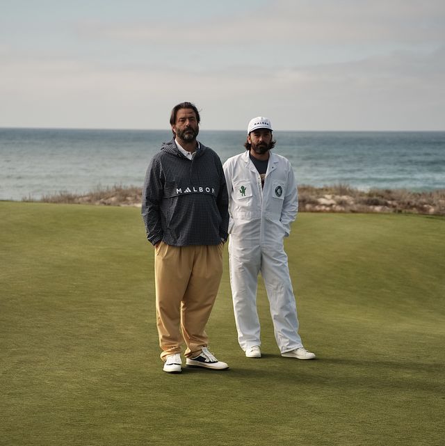 two men standing on a golf course