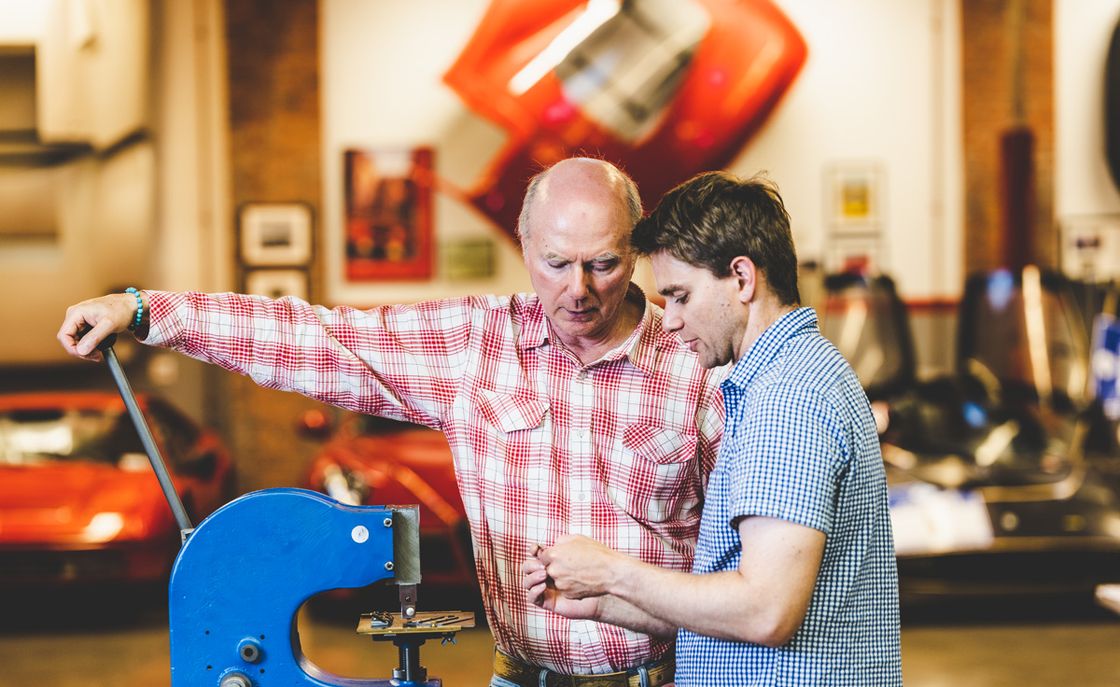 James and Jesse Glickenhaus at shop with VIN stamping press