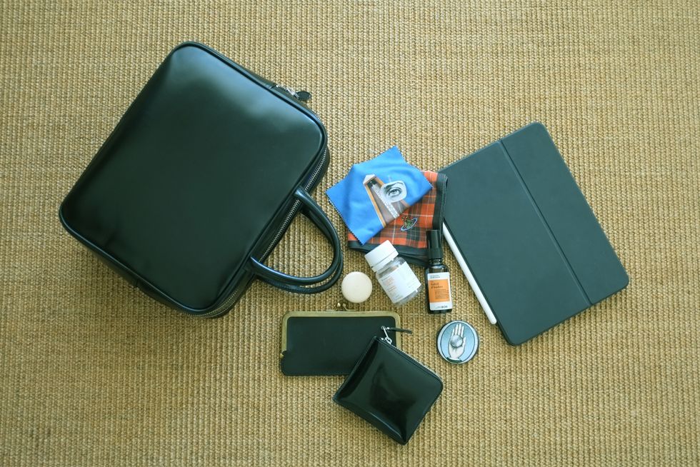 a suitcase and a watch on the floor