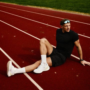 athlete resting on a running track after a workout athlete resting on a running track after a workout