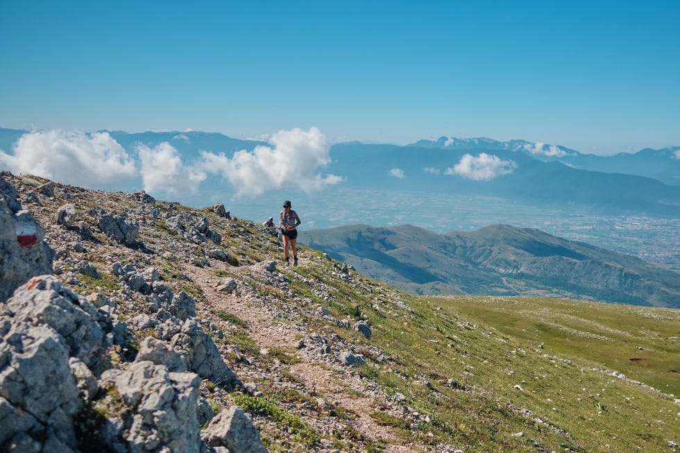 mountain trail running with views of distant mountains and valleys