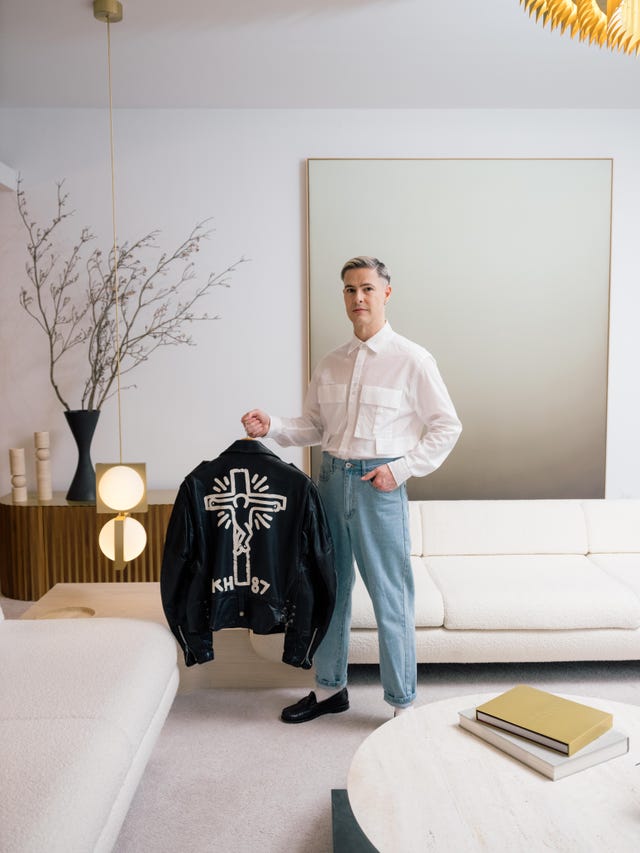 individual showcasing a black jacket with a cross design