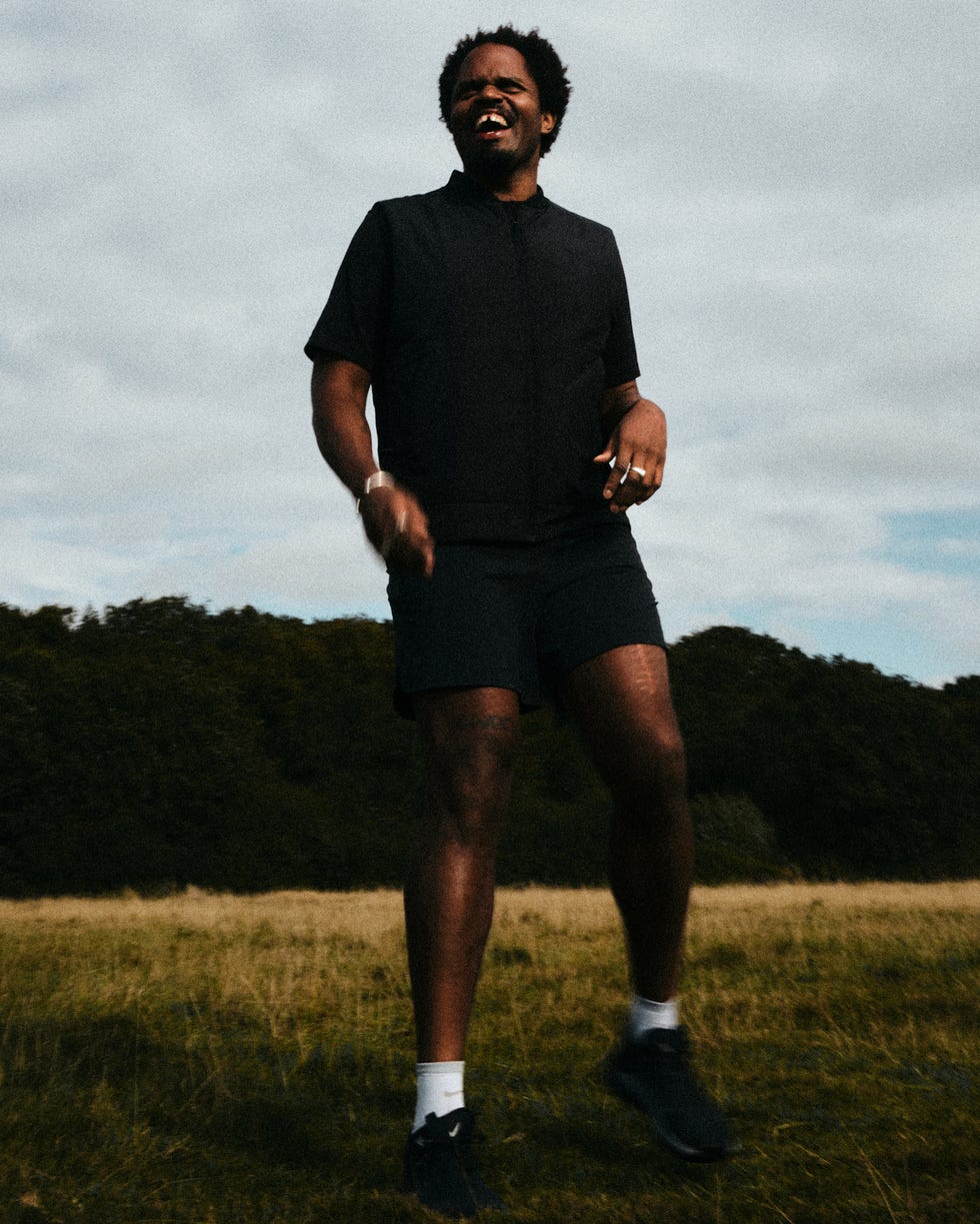 tyler smiling in a grassy field