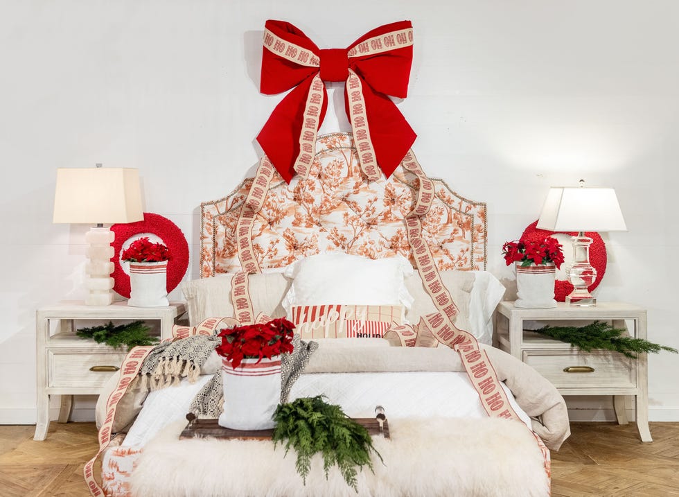 a white bedroom with red and white decor