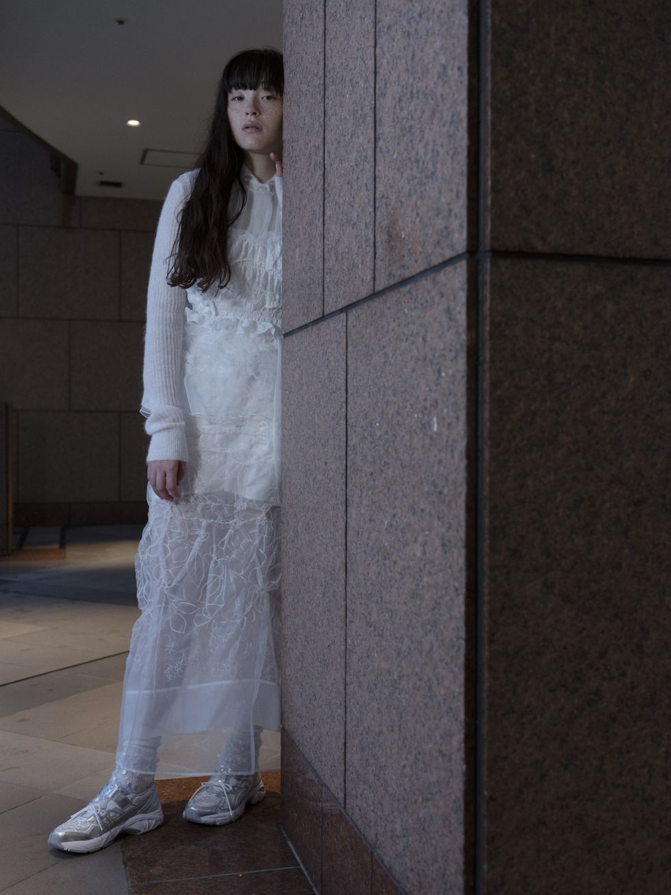 a model wears the cecilie bahnsen asics while standing in a hallway