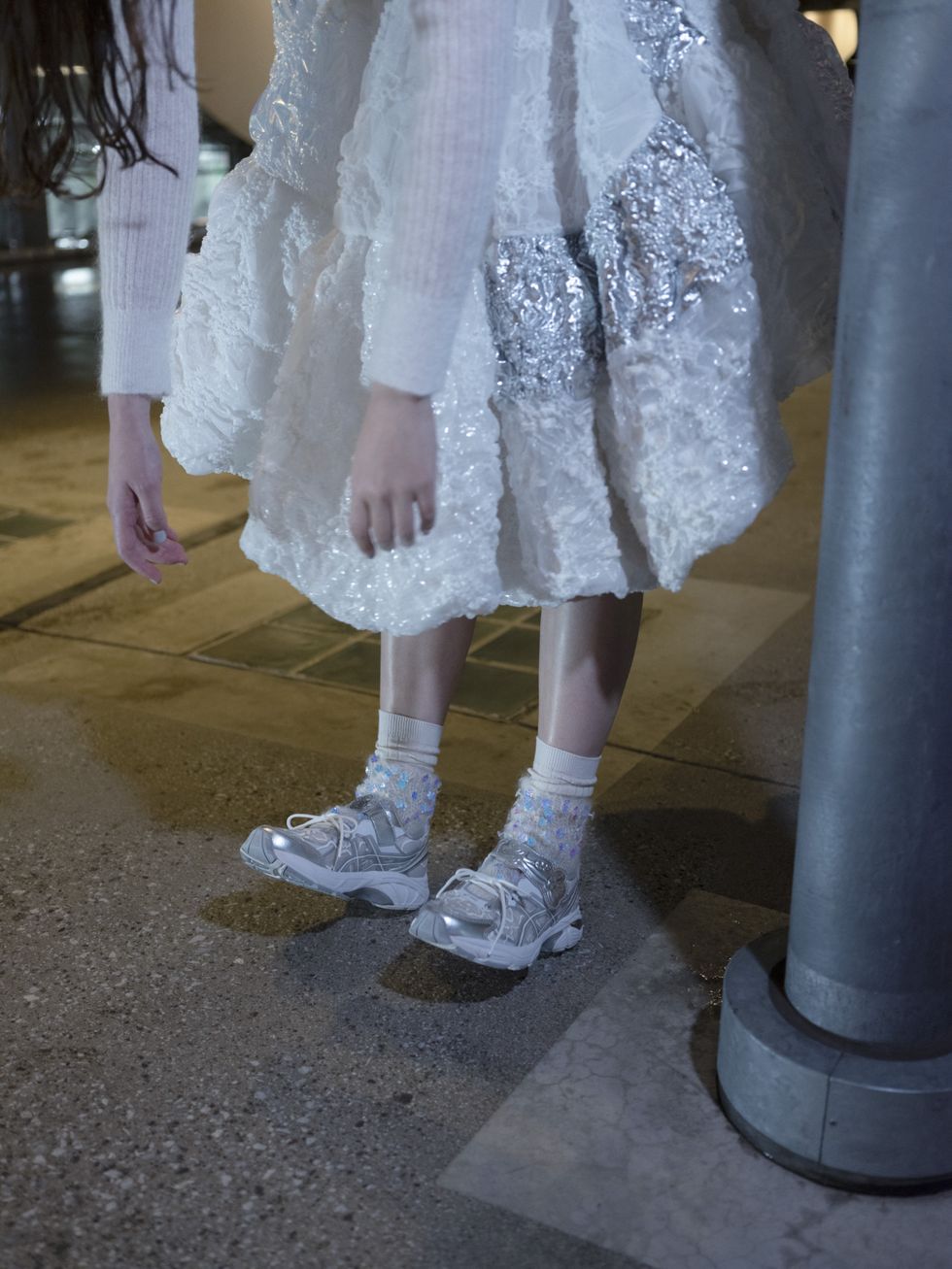 a model wears cecilie bahnsen asics sneakers with a white cecilie bahnsen dress