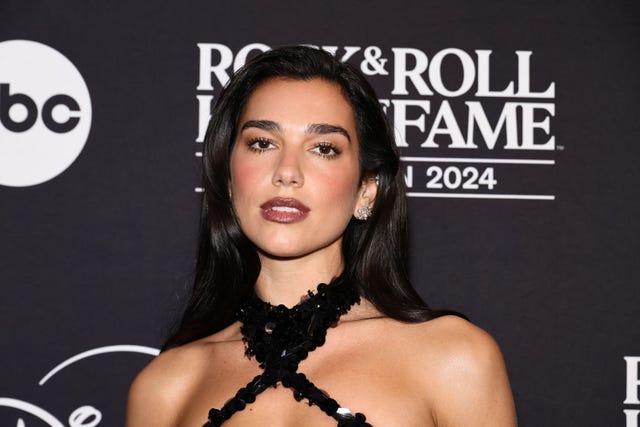 Dua Lipa's xmas fit consists of teeny white hotpants and Santa hat