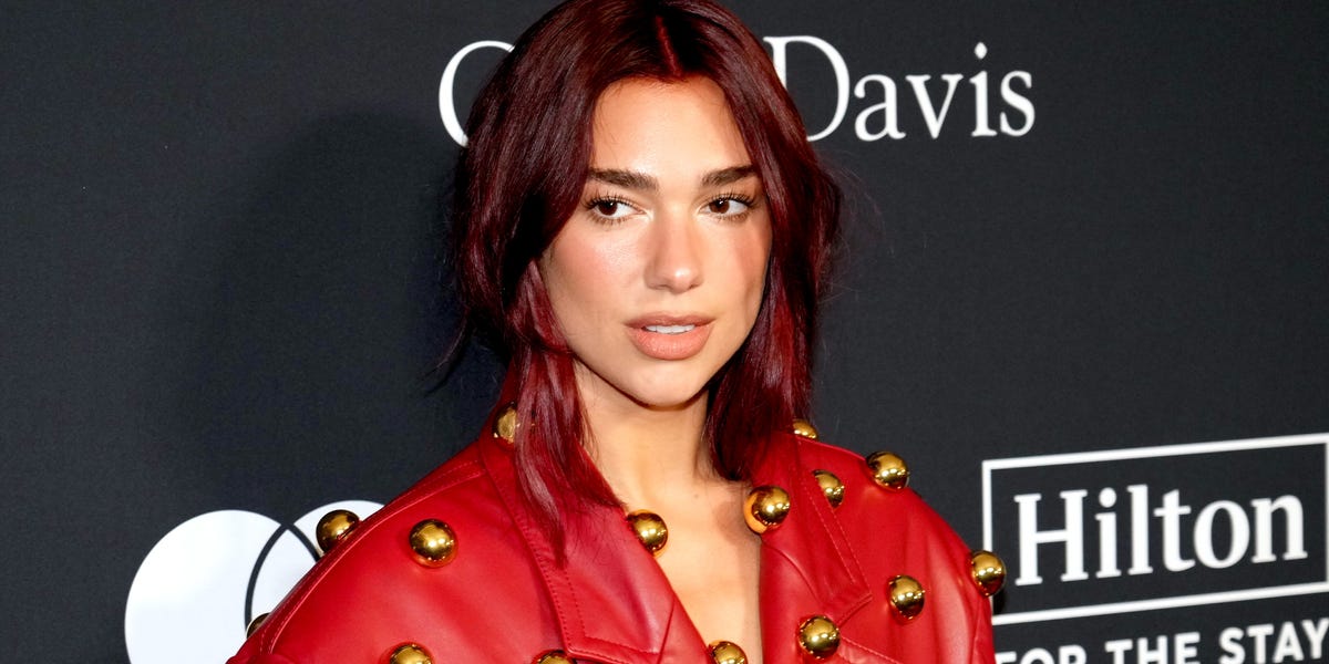 Dua Lipa Wears Eye-Catching Red Leather Trench Coat Covered With Gold ...