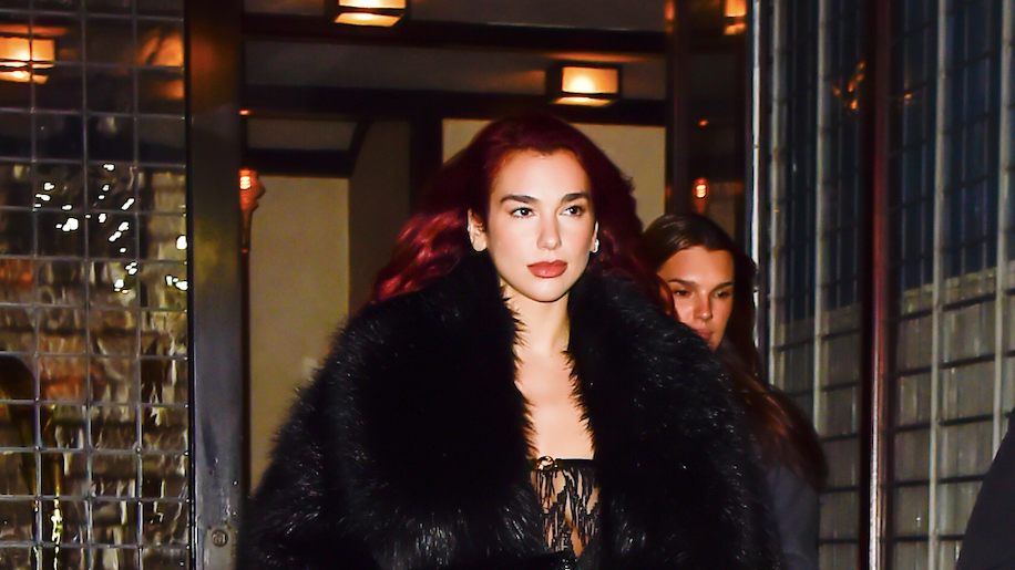 Dua Lipa goes braless in see-through black gown with leg slit