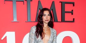 dua lipa wearing custom chanel to the time100 gala her look features an embellished silver dress with a deep v neck cut out and a large bow