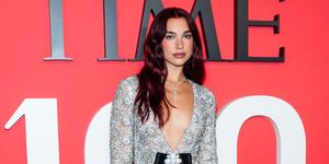 dua lipa wearing custom chanel to the time100 gala her look features an embellished silver dress with a deep v neck cut out and a large bow