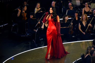 dua lipa performs at the royal albert hall in a red satin dress