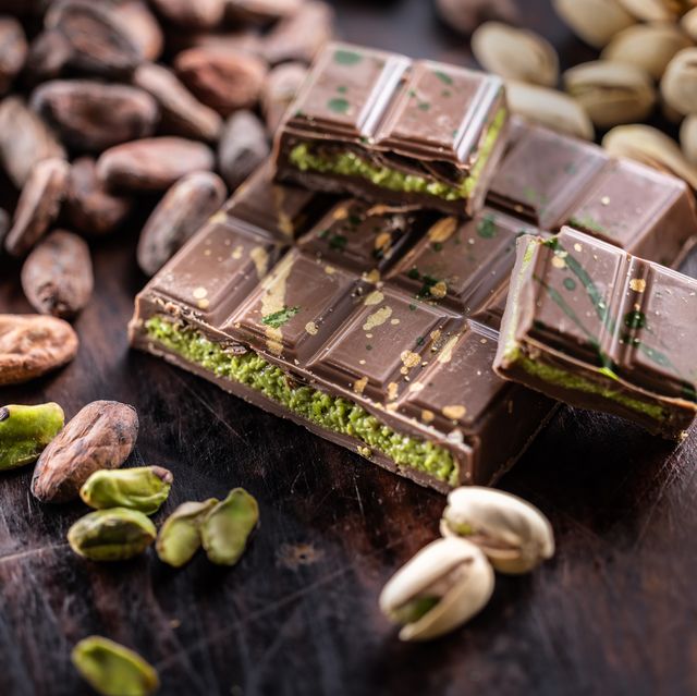 dubai chocolate bar with green kadayif and pistachio spread with pistachio nuts close up