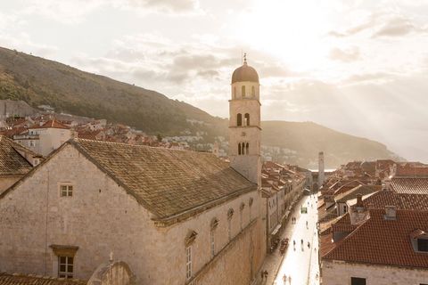 Een franciscaans klooster torent uit boven de Placa de met kalksteen geplaveide hoofdstraat van de historische Oude Stad van Dubrovnik in Kroati